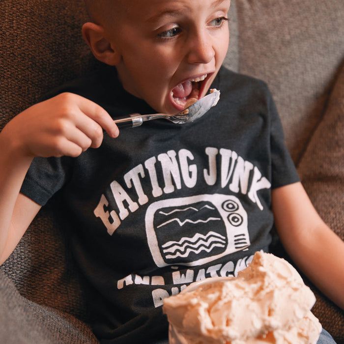 Youth Eating Junk And Watching Rubbish